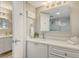 Clean and modern bathroom featuring dual vanities, a large mirror, and a shower at 2055 Gulf Of Mexico Dr # G2-108, Longboat Key, FL 34228