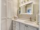 Well-lit bathroom with a vanity, sink, and mirror with decorative lighting fixtures at 2055 Gulf Of Mexico Dr # G2-108, Longboat Key, FL 34228