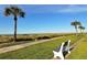 Scenic beach view from lush, landscaped walkway, a serene escape at 2055 Gulf Of Mexico Dr # G2-108, Longboat Key, FL 34228