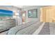 Comfortable bedroom with a dresser, television and a view into the kitchen from the doorway at 2055 Gulf Of Mexico Dr # G2-108, Longboat Key, FL 34228