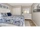 Relaxing bedroom features a large bed, ample closet space and a dresser with mirror at 2055 Gulf Of Mexico Dr # G2-108, Longboat Key, FL 34228