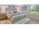 Cozy bedroom features a comfortable queen-size bed, soft rug, and a bright window overlooking the landscape at 2055 Gulf Of Mexico Dr # G2-108, Longboat Key, FL 34228
