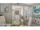 A well-lit dining area with a glass table, views into the updated kitchen, and modern decor at 2055 Gulf Of Mexico Dr # G2-108, Longboat Key, FL 34228