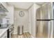 A modern kitchen with stainless steel appliances, a stainless steel trash can, and a view through to the dining area at 2055 Gulf Of Mexico Dr # G2-108, Longboat Key, FL 34228