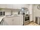 A stylish, updated kitchen featuring stainless steel appliances, marble countertops, and modern fixtures at 2055 Gulf Of Mexico Dr # G2-108, Longboat Key, FL 34228