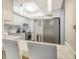 Bright kitchen with stainless steel appliances, breakfast bar with white marble countertop and pendant lighting at 2055 Gulf Of Mexico Dr # G2-108, Longboat Key, FL 34228