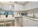 A bright kitchen featuring sleek stainless-steel appliances, white marble countertops, and modern fixtures at 2055 Gulf Of Mexico Dr # G2-108, Longboat Key, FL 34228