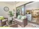 Comfortable, covered lanai with tile floor, exterior view, and wicker furnishings at 2055 Gulf Of Mexico Dr # G2-108, Longboat Key, FL 34228