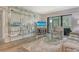 A cozy living room featuring modern décor, light wood floors, and a view of the outdoors through a sliding glass door at 2055 Gulf Of Mexico Dr # G2-108, Longboat Key, FL 34228