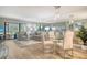 An open-concept living and dining area with comfortable seating, a glass dining table, and natural light at 2055 Gulf Of Mexico Dr # G2-108, Longboat Key, FL 34228