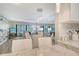 Open-concept living and dining area with light wood floors, neutral colors, stylish furnishings and view of the outside at 2055 Gulf Of Mexico Dr # G2-108, Longboat Key, FL 34228