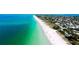 Stunning aerial view of a pristine white sand beach and turquoise ocean water near residential community at 2330 7Th W Ave, Bradenton, FL 34205