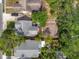 Overhead view shows home's backyard brick design with tropical landscaping nestled among trees at 2330 7Th W Ave, Bradenton, FL 34205