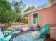 Backyard patio features stylish blue rug, seating, and lush surroundings perfect for relaxation at 2330 7Th W Ave, Bradenton, FL 34205