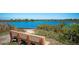 Bench overlooking a serene pond with lush greenery, offering a peaceful escape in the community at 2330 7Th W Ave, Bradenton, FL 34205