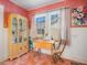Bright dining area with vintage-style table set, antique cabinet, and natural light at 2330 7Th W Ave, Bradenton, FL 34205