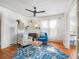 Bright and airy living room with a fireplace, hardwood floors, ceiling fan, and elegant furnishings at 2330 7Th W Ave, Bradenton, FL 34205