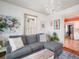 Cozy living room featuring a gray sectional sofa, hardwood floors, and a decorative chandelier at 2330 7Th W Ave, Bradenton, FL 34205