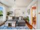 Cozy living room featuring a gray sectional sofa, hardwood floors, and a decorative chandelier at 2330 7Th W Ave, Bradenton, FL 34205
