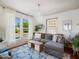 Cozy living room featuring a gray sectional sofa, hardwood floors, and a decorative chandelier at 2330 7Th W Ave, Bradenton, FL 34205
