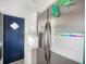 Practical mud room with stainless steel refrigerator and convenient laundry facilities at 2330 7Th W Ave, Bradenton, FL 34205