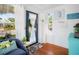 Cozy sun room featuring a blue sofa, bright lighting, hardwood floors, and white wainscotted walls at 2330 7Th W Ave, Bradenton, FL 34205