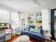 Cozy sun room with comfortable blue couch, bright windows, and hardwood floors at 2330 7Th W Ave, Bradenton, FL 34205