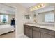 Bathroom featuring double vanity with granite counters and view to bedroom with view at 2332 Mizner Bay Ave, Bradenton, FL 34208