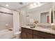 Bathroom features a double vanity, tiled shower, and granite countertop at 2332 Mizner Bay Ave, Bradenton, FL 34208