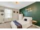 Bedroom with statement green accent wall, modern decor, and chandelier lighting at 2332 Mizner Bay Ave, Bradenton, FL 34208