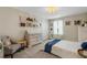 Bright bedroom with decorative wall art, chandelier and closet with white double doors at 2332 Mizner Bay Ave, Bradenton, FL 34208