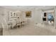 Elegant dining room with chandelier, set table, and decorative hutch, perfect for entertaining at 2332 Mizner Bay Ave, Bradenton, FL 34208