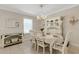 Bright dining area featuring a chandelier, hutch, and a set table for a cozy meal at 2332 Mizner Bay Ave, Bradenton, FL 34208