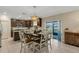 Open-concept dining area featuring modern lighting and access to kitchen and outdoor space at 2332 Mizner Bay Ave, Bradenton, FL 34208