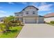 Charming two-story home with a three car garage, manicured lawn and beautiful landscaping at 2332 Mizner Bay Ave, Bradenton, FL 34208