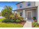 Inviting covered front porch with decorative landscaping and stylish entry door at 2332 Mizner Bay Ave, Bradenton, FL 34208
