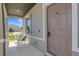 A charming front porch featuring two white rocking chairs and a view of the neighborhood at 2332 Mizner Bay Ave, Bradenton, FL 34208