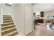 Hallway featuring carpeted stairs, coat closet, and an entrance to the kitchen at 2332 Mizner Bay Ave, Bradenton, FL 34208