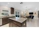 Open kitchen and dining area featuring modern appliances, granite countertops, and tile flooring at 2332 Mizner Bay Ave, Bradenton, FL 34208