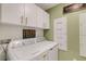 Modern laundry room with front loading washer and dryer and storage at 2332 Mizner Bay Ave, Bradenton, FL 34208