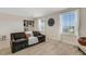 Inviting bonus room with comfortable couch, large windows, and decorative wall art at 2332 Mizner Bay Ave, Bradenton, FL 34208