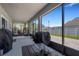Covered patio with outdoor seating area and great views of the backyard and fence at 2332 Mizner Bay Ave, Bradenton, FL 34208