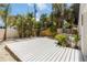 Spacious backyard with a wooden deck and lush tropical landscaping at 2410 Floyd St, Sarasota, FL 34239