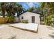 Backyard of white house featuring a wooden deck and small plants at 2410 Floyd St, Sarasota, FL 34239