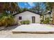A backyard featuring a modern deck, landscaping, and the exterior of the home at 2410 Floyd St, Sarasota, FL 34239