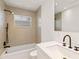 Bright bathroom featuring a shower-tub combo, sleek sink, and modern fixtures at 2410 Floyd St, Sarasota, FL 34239