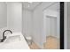 Modern half bath featuring a toilet, sleek sink, and open doorway at 2410 Floyd St, Sarasota, FL 34239
