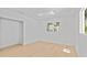 Bright bedroom features wood flooring and a window overlooking the neighborhood at 2410 Floyd St, Sarasota, FL 34239