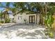 Charming single-story home with a well-manicured front yard, modern black trim, and black double door entry at 2410 Floyd St, Sarasota, FL 34239