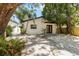 Charming single-story home with a well-manicured front yard, modern black trim, and black double door entry at 2410 Floyd St, Sarasota, FL 34239